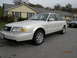 1995 Audi A6 - A white 1995 Audi A6 sedan is parked on a residential street.