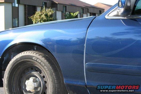 Blue car fender and door with subtle flame graphics