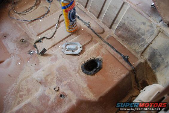 Interior floor pan with AutoZone brake cleaner can and wiring