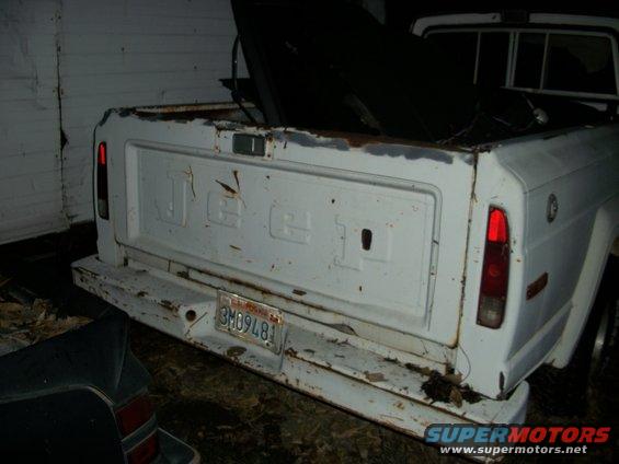 White 1976 Jeep J-10 tailgate with visible JEEP lettering and California license plate