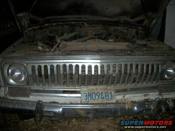1976 Jeep J-10 front end with hood open, showing engine bay covered in dust. California license plate 3M09481 is visible