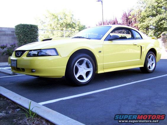 Yellow 2002 Ford Mustang parked in a lot