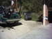 1996 Harley-Davidson Super Glide - A dark motorcycle is loaded into the bed of a green pickup truck.