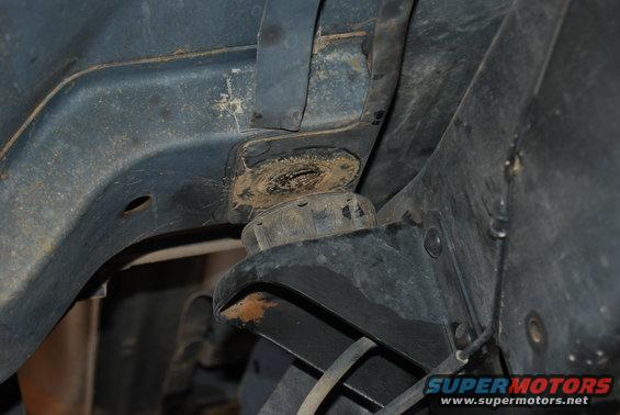 Close-up of vehicle frame structure with suspension mounting point