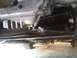 1994 Ford Probe - The underside of a vehicle reveals a transmission with Mazda branding and visible suspension parts.
