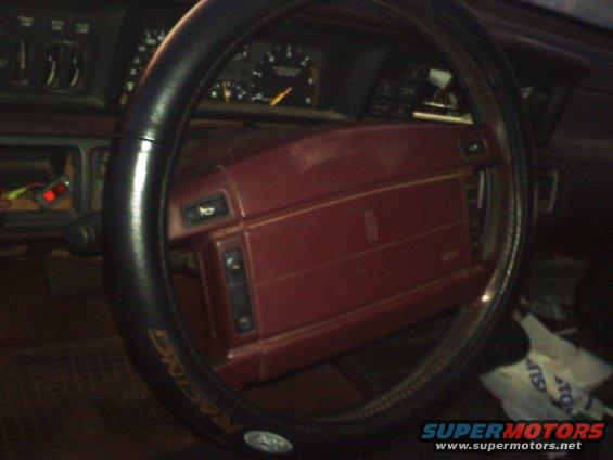 Red dashboard and steering wheel interior of a car