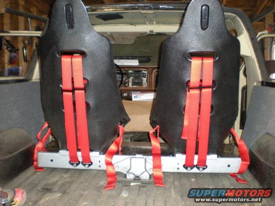 1978 Ford Bronco interior with two black racing seats and red harnesses