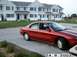 1998 Mercury Sable - Red 1998 Mercury Sable sedan parked in front of a row of townhouses.