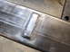 1989 Ford Bronco - Close-up view of a metal frame a freshly welded rectangular patch.