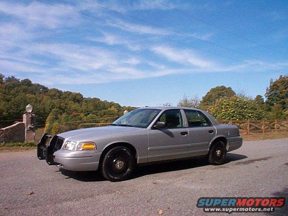 2004 Ford Crown Victoria sedan with black push bar and black steel wheels parked on asphalt