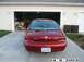 1998 Mercury Sable - Rear view of a red sedan parked in front of a garage. The license plate reads 980 GHP.