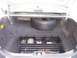 2004 Ford Crown Victoria - The trunk of a car contains a spare tire and a multi-compartment organizer with various items.