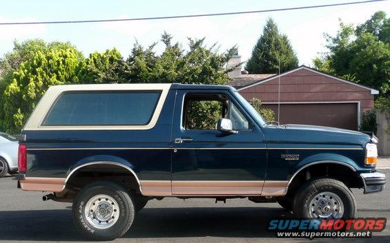 1995 Ford Bronco, dark blue with tan trim, side view