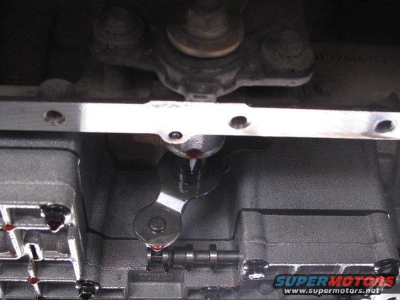 Close-up of a transmission valve body with red fluid dripping