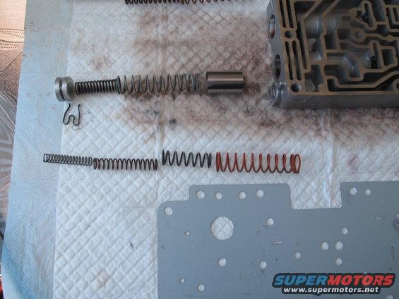 Transmission valve body with disassembled springs and metal plate
