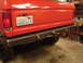 1989 Ford Bronco - The rear of a red SUV shows a custom metal bumper and a Washington license plate.