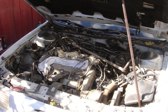 1990 Ford Taurus engine bay with engine covered