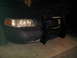 2003 Ford Crown Victoria - The front of a black 2003 Ford Crown Victoria is visible, equipped with a heavy-duty push bar.