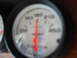 1992 Ford C-350 (Centurion Conversions) - A close-up shot of a vehicle's gauge, showing a red needle indicating a reading on the dial.