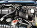 1992 Ford C-350 (Centurion Conversions) - The engine bay of a 1992 Ford C-350 (Centurion Conversions) is visible, the intake air system and radiator.
