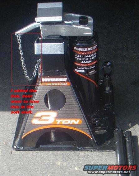 Powerbuilt 3-ton truck lift jack with chain attached to safety latch