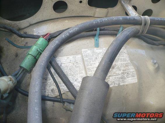 Engine bay with hoses and 1986 emission sticker