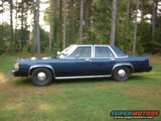 Dark blue 1990 Ford Crown Victoria sedan, side view