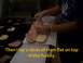 1989 Ford Bronco - A person is shown making a sandwich, layering ham on bread at a sandwich counter.
