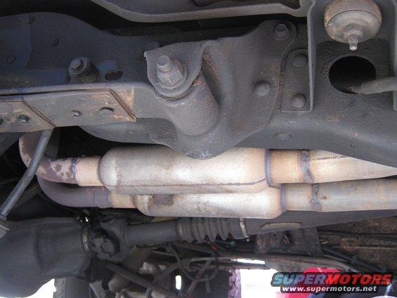 Underside view of dual exhaust pipes and mufflers on a vehicle