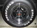 1973 Ford Ranchero - A close-up view of a chrome wheel with a red and gold center cap, fitted with Goodyear Eagle GTI tires.