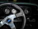 1973 Ford Ranchero - The interior of a 1973 Ford Ranchero shows a custom steering wheel and a dashboard with multiple gauges.