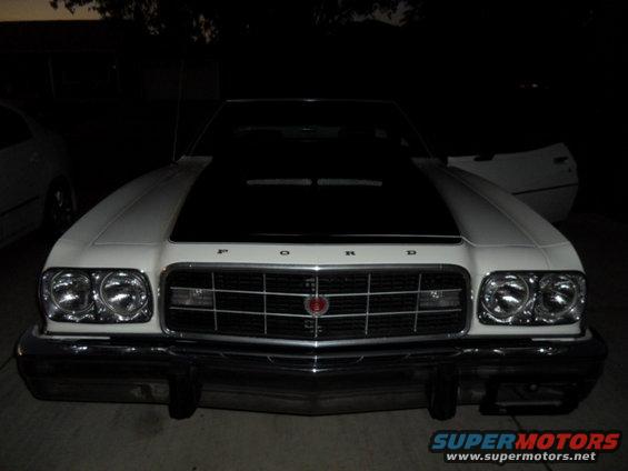 White 1973 Ford Ranchero front view, black hood, chrome grille, dual headlights