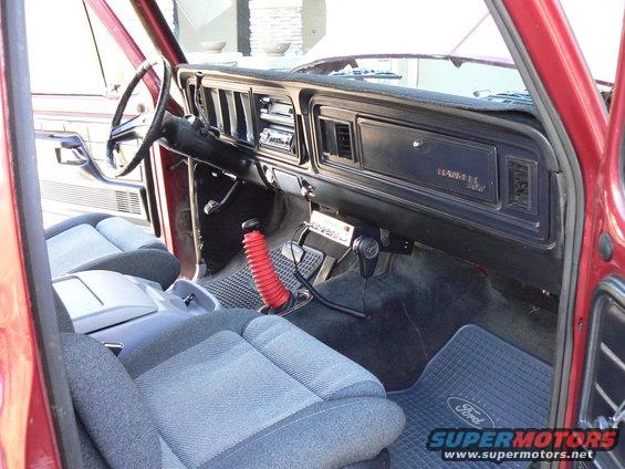 Interior of a 1978 Ford Bronco showing dashboard, seats, and shifter