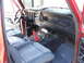 1978 Ford Bronco - The interior of a 1978 Ford Bronco features a red shifter boot and Ford-branded floor mats.