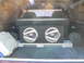 1978 Ford Bronco - Vehicle interior cargo area with a large subwoofer box and a storage container visible.