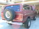 1978 Ford Bronco - Rear three-quarter view of a maroon 1978 Ford Bronco parked in a garage.