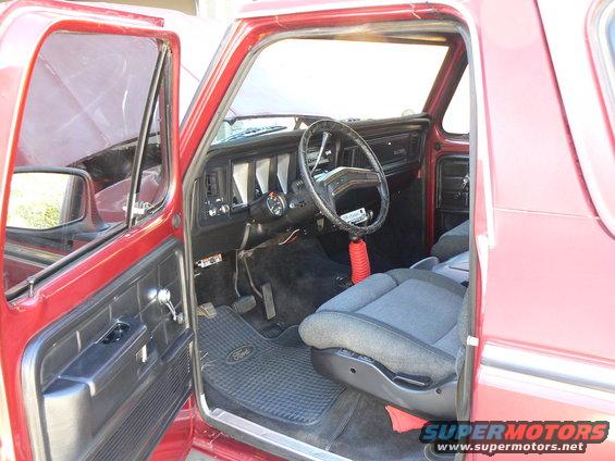 1978 Ford Bronco interior with gray seats and black dashboard