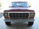 1978 Ford Bronco - Front view of a maroon 1978 Ford Bronco with a prominent chrome grille and a Texas Longhorns license plate frame.