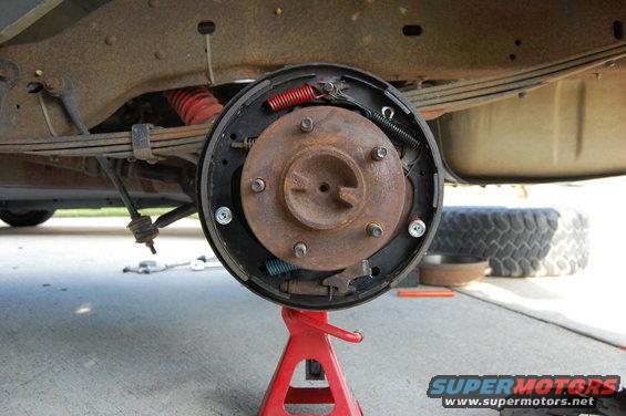 Rear drum brake assembly on red jack stand
