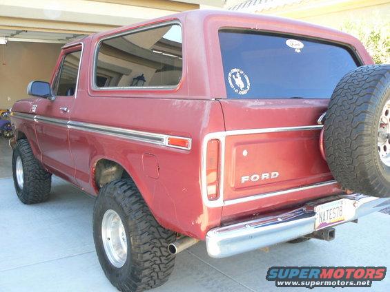 Red 1978 Ford Bronco parked in garage, rear view with spare tire and license plate