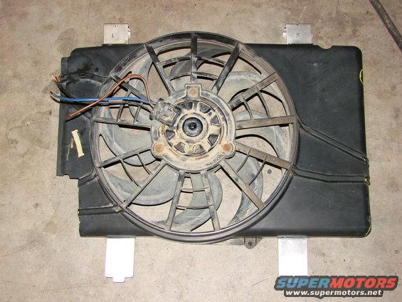 Radiator fan assembly with wiring, mounted on a concrete floor