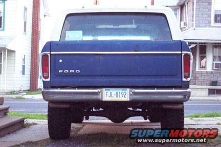 Rear of a blue Ford Bronco with a white top. License plate reads FJL-0192