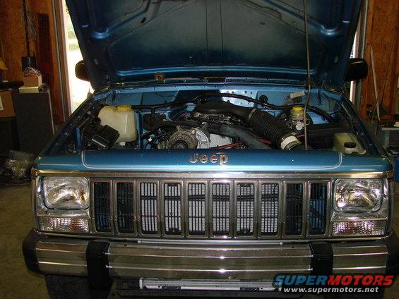 1991 Jeep Comanche engine bay with hood open, showing engine and front grille