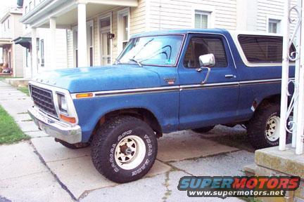Blue 1979 Ford Bronco parked on a sidewalk