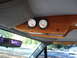 1992 Ford C-350 (Centurion Conversions) - Custom wooden overhead console with oil and water temperature gauges visible inside a vehicle.