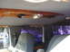 1992 Ford C-350 (Centurion Conversions) - The interior of a vehicle shows an overhead console with wood trim and multiple lights, along with seats and windows.