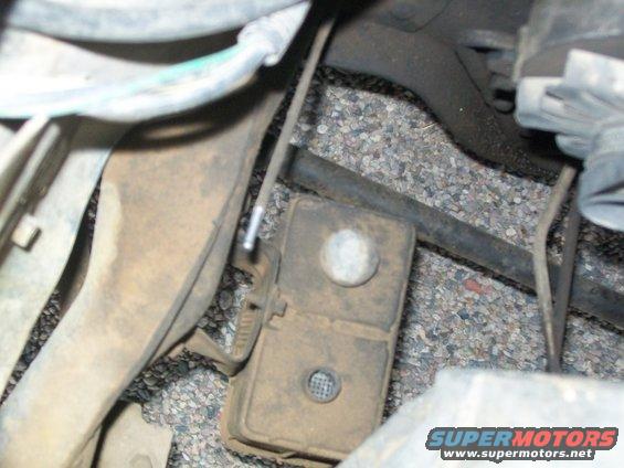 Undercarriage component with wires and a Supermotors.net watermark