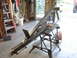 1989 Ford Bronco - A metal fabrication project is set up on a sawhorse in a garage, with various tools visible.