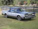1972 Ford Ranchero - This two-tone pickup truck, likely from the early 1980s, features a distinctive vinyl roof and a unique utility bed.
