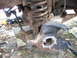 1996 Ford F-150 - Close-up view of heavily corroded front suspension components, suggesting a need for repair or replacement.